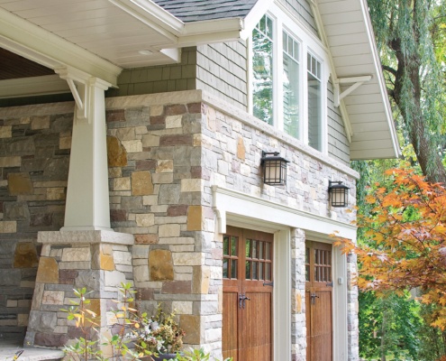 Mississauga renovation with natural stone, tapered columns and wood siding.