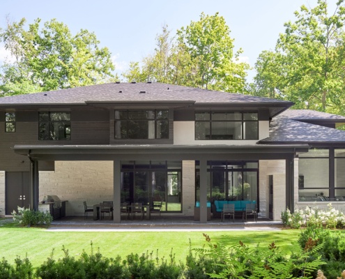 Mississauga house with black frame windows, metal cladding and flat roof.