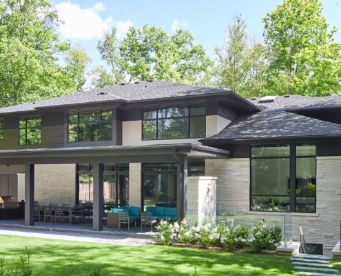 Natural modern home with floating roof, wood siding and natural stone.