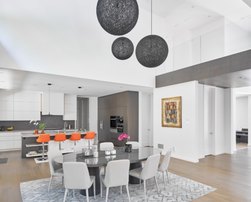 Modern kitchen with wood cabinets, breakfast bar and white trim.