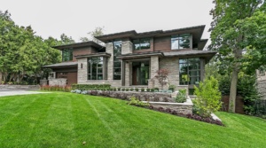 Contemporary house with black frame window, steel column and landscape wall.