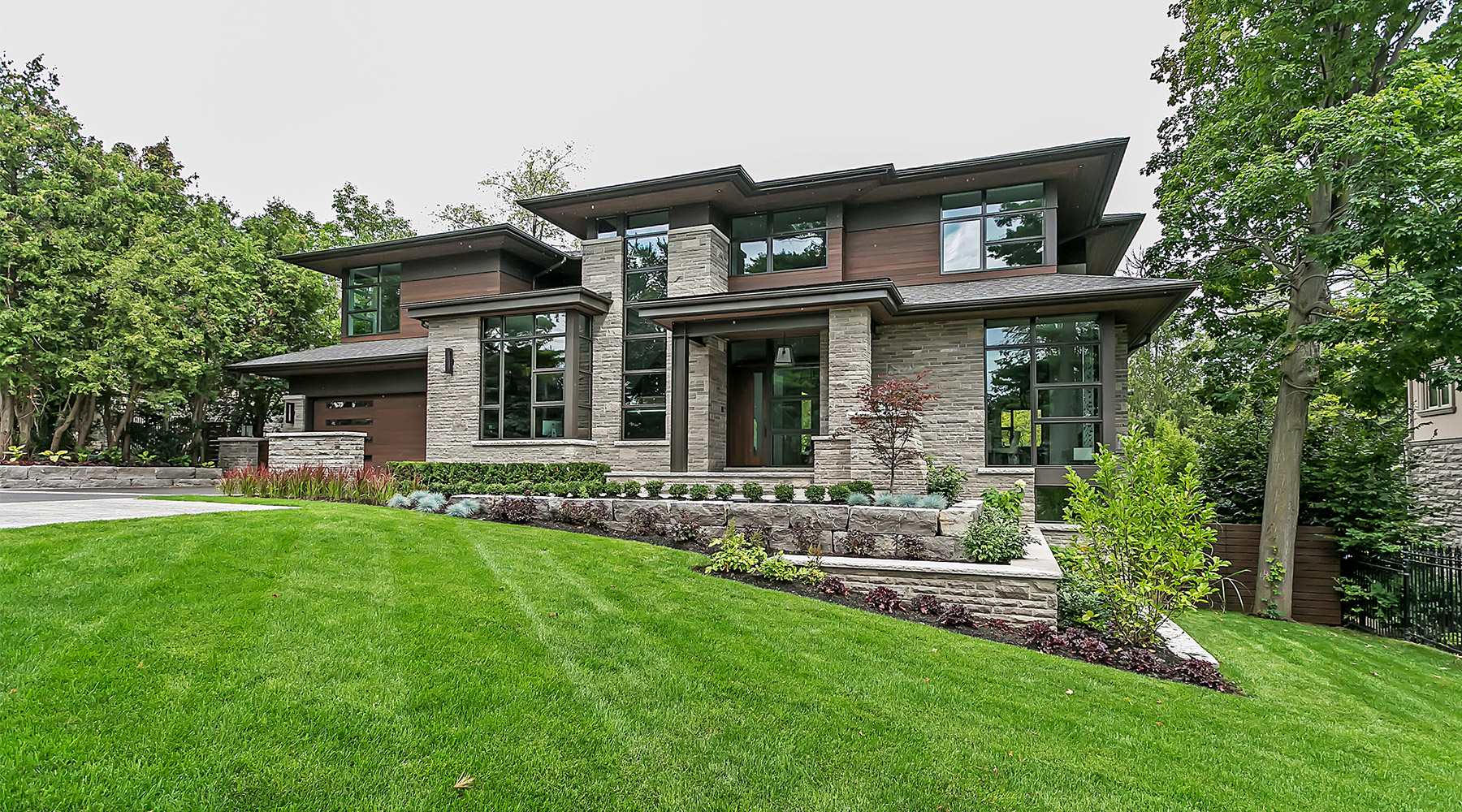 Contemporary house with black frame window, steel column and landscape wall.