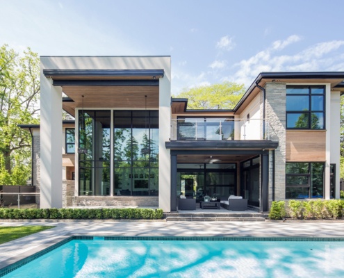 Ultra modern home with second floor balcony, flat roof and steel columns.