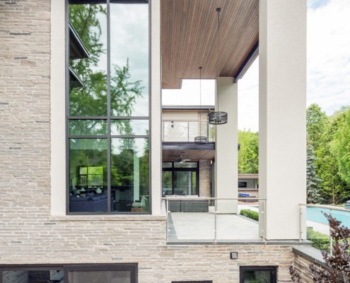 Contemporary home with wood soffit, stucco columns and flagstone patio.