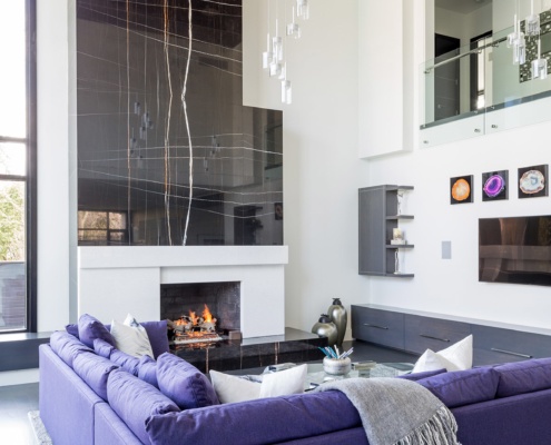 Family room with two storeys, wood ceiling and modern chandelier.