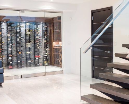 Wood cellar with glass door, tile floor and floating stair.
