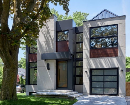 Toronto home with floor to ceiling windows, wood siding and peaked roof.