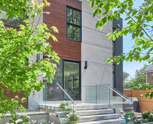 Contemporary house with black frame window, clean lines and stone steps.