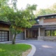 Front exterior of home with stucco siding, natural stone and pergola.