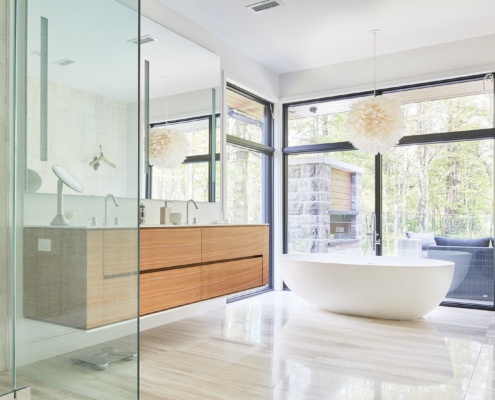 Master bathroom with floating vanity, corner window and white baseboard.