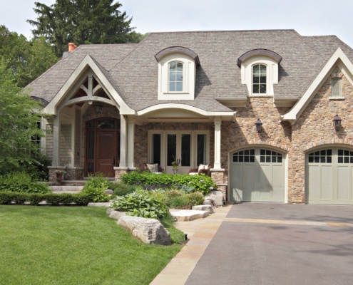 Mississauga house with gables, wood front door and white trim.