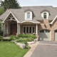 Mississauga house with gables, wood front door and white trim.