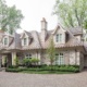 Traditional home with natural stone, shutters and two chimneys.