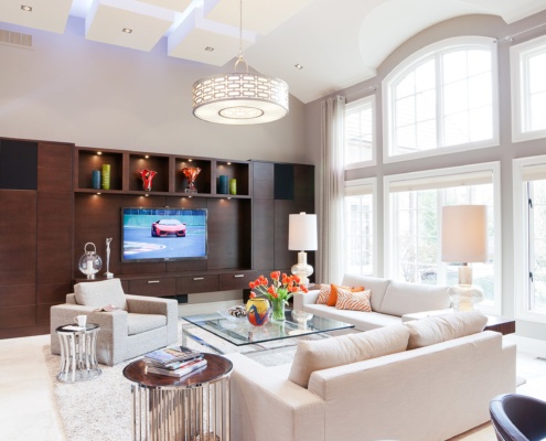 Living room with built in cabinets, tile floor and vaulted ceiling.