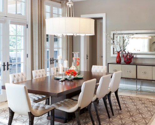 Dining room with french doors, tile floor and white trim.