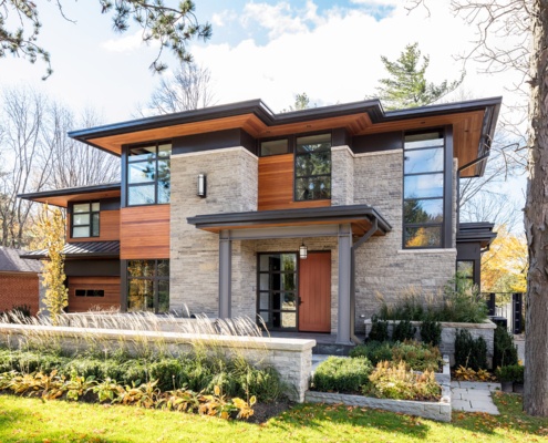 House front elevation with corner windows, wood soffit and metal cladding.