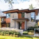 House front elevation with corner windows, wood soffit and metal cladding.