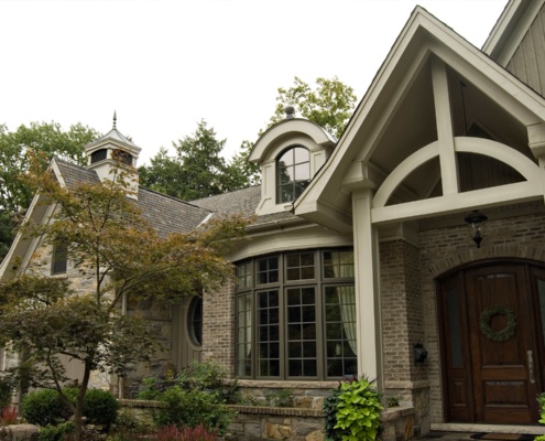 Traditional house with cupola, brick and large windows.