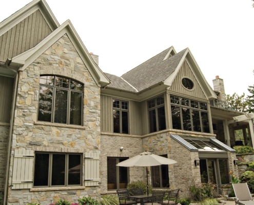 Missisauga house with shutters, natural stone and brick.