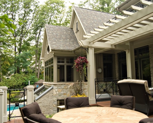 Backyard deck with natural stone, wood floor and shingled roof.