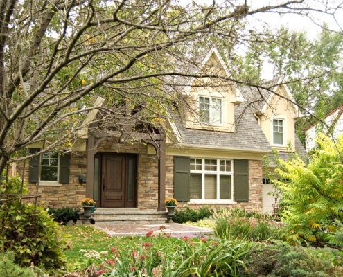 Mississauga renovation with shutters, white frame windows and gables.