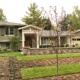 Mississauga renovation with wood siding, natural stone and shutters.