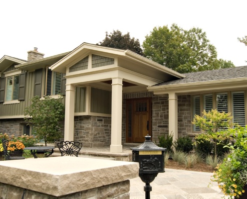 Front facade with natural stone, shutters and wood siding.