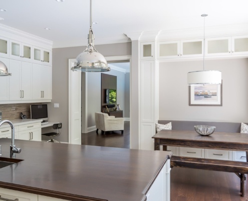 Kitchen with hardwood countertop, white trim and hardwood floor.