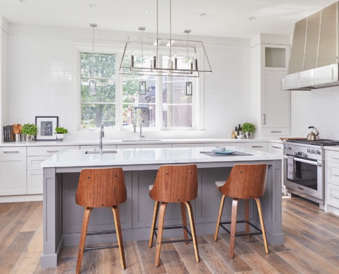 Kitchen with wood floor, tile backplash and pendant lighting.