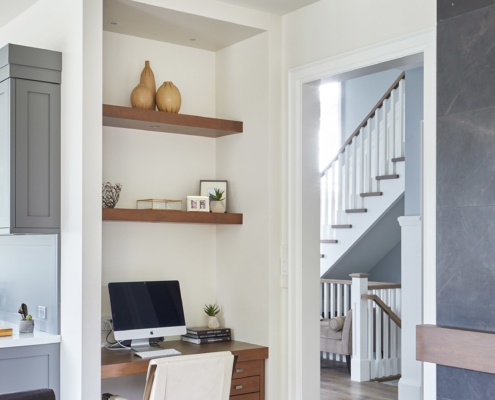 Home office with wood desk, hardwood floor and built shelves.