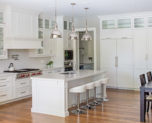 Oakville home with breakfast bar, white countertops and white backsplash.