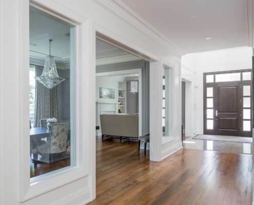 Front entry with brown front door, wood floor and white accents.