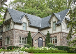 Front elevation with gables, shingled roof and beige frame windows.