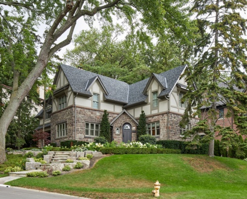 Toronto renovation with stone siding, grid windows and shingled roof.