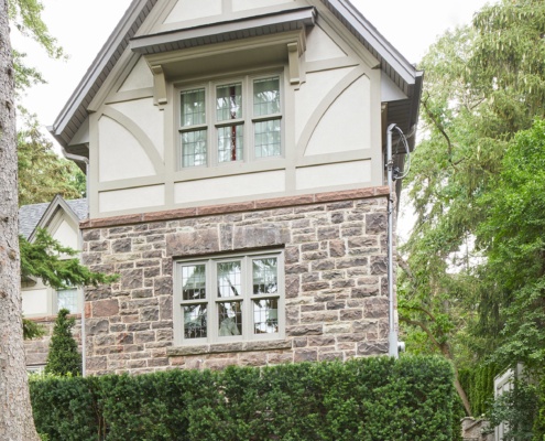 Toronto renovation with natural stone, stucco siding and grid windows.