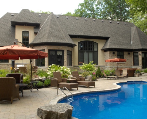 Traditional home with brick, stucco siding and black frame window.