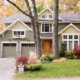 Traditional architecture with gabled roof, stone chimney and window box.