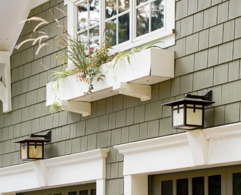 Mississauga house with stucco siding, wood siding and window box.