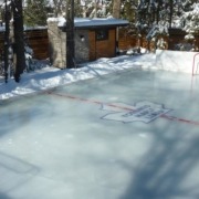 Ice rink in backyard of modern home.