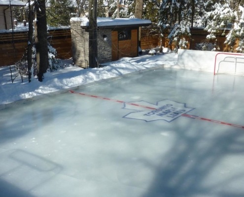 Ice rink in backyard of modern home.