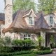 Custom home with white frame windows, white columns and copper detailing.