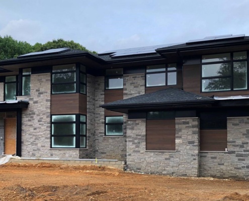 US house with large overhangs and solar panels.