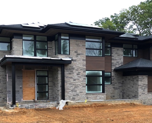 Contemporary house with stone and wood siding.