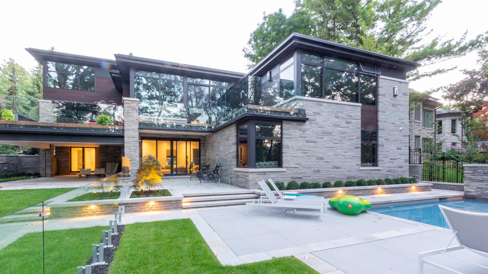 Natural modern home with stone siding, wood siding and large balcony.