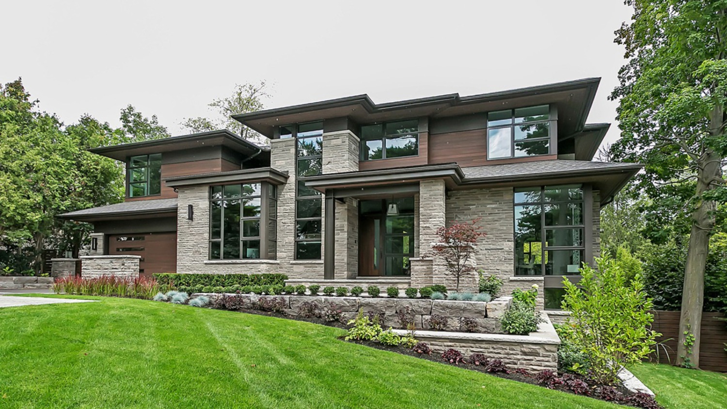Contemporary home with natural stone, wood siding and corner windows.