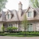 Traditional home front entry with white column, wood front door and flagstone walkway.