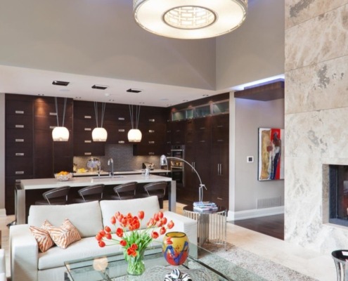 Home front entry with stone fireplace, hardwood floor and white baseboard.