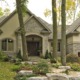 Mississauga renovation with stucco siding, wood garage door and arched windows.