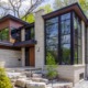 Mississauga house with stone columns, wood front door and wall sconce.