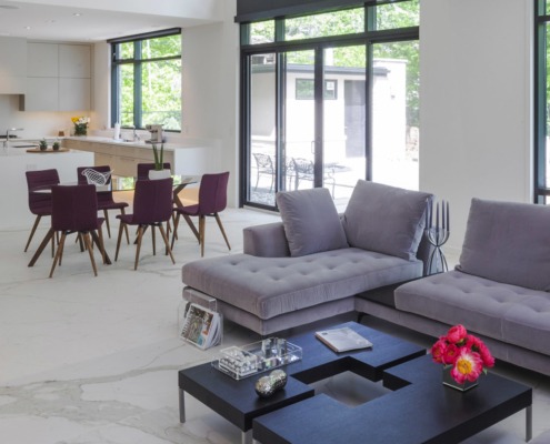 Family room with black frame windows, white trim and marble floor.